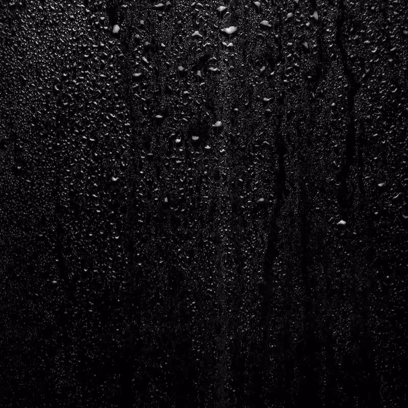Raindrops on dark glass